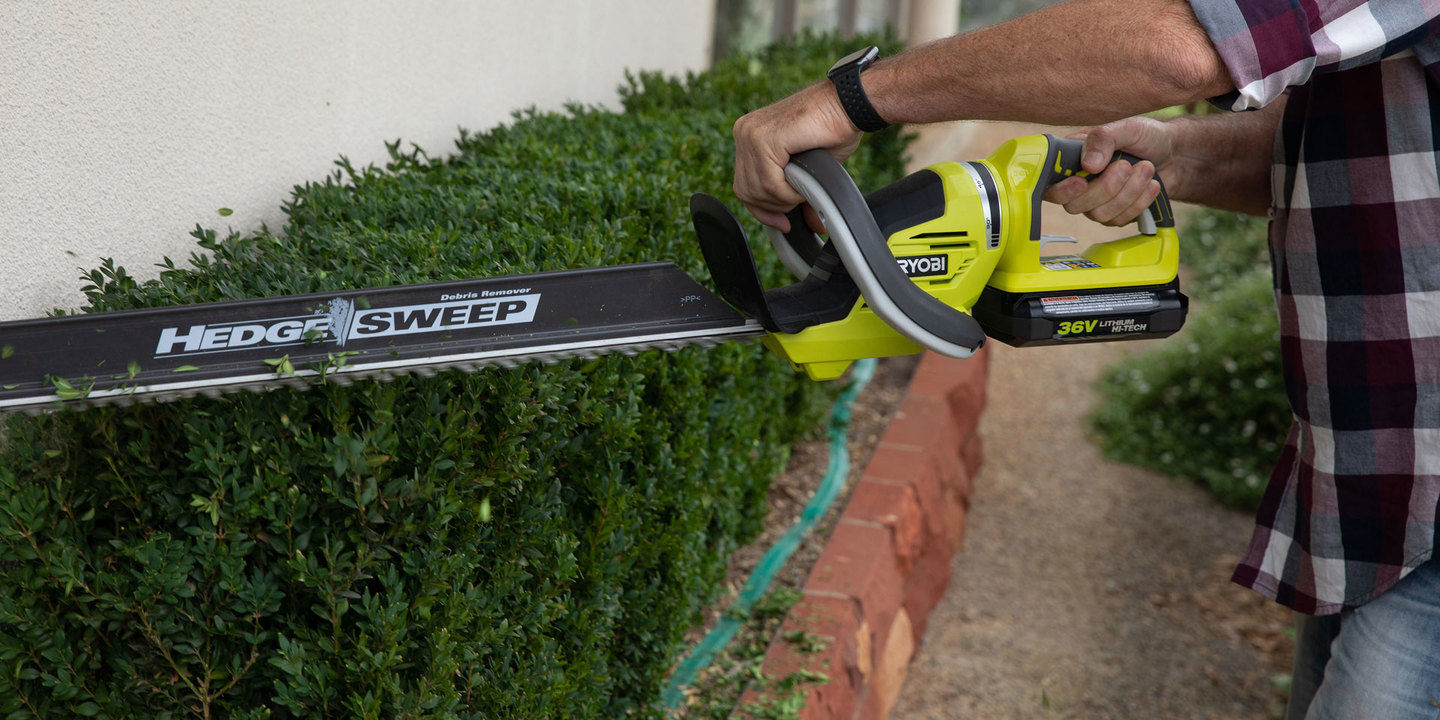 A Ryobi hedge trimmer with hedge sweep blade