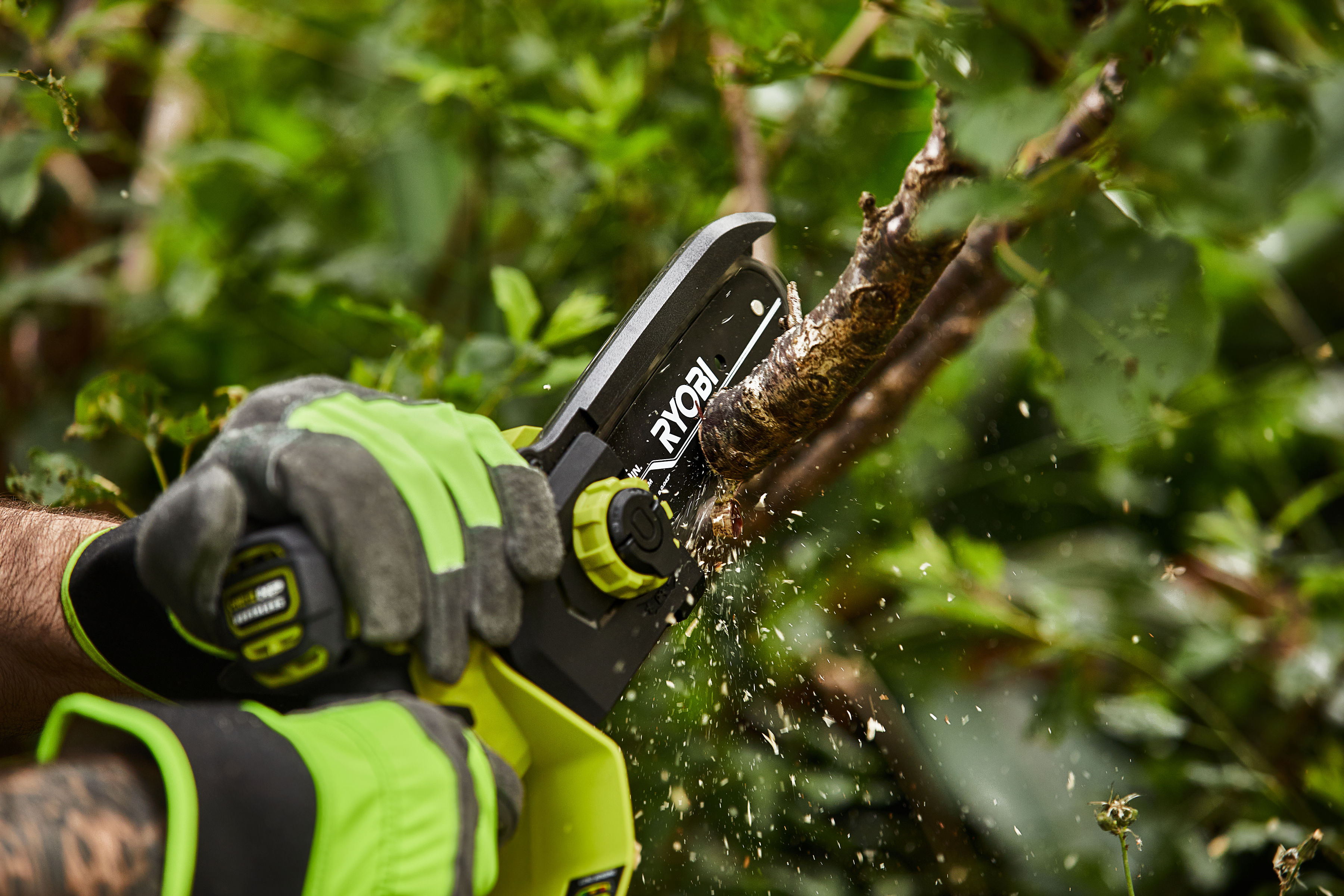 RYOBI Pruning Saw cutting through tree branches