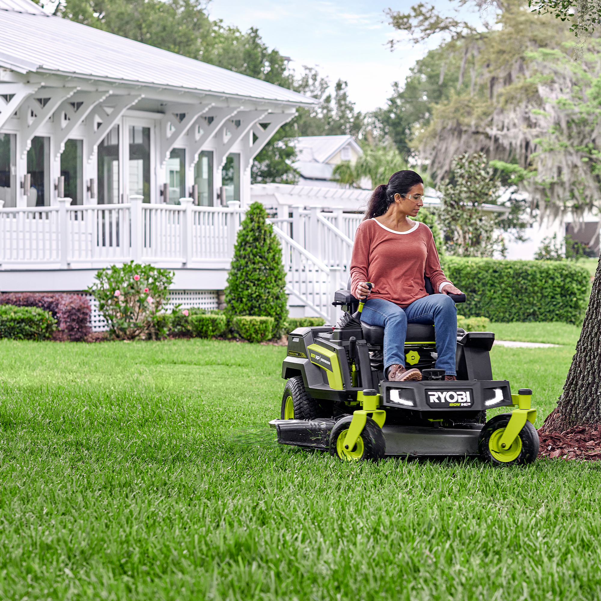 Woman driving a RYOBI 80V Ride On Mower