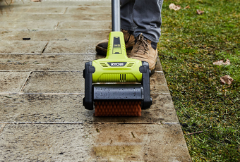 Ryobi scrubbing tool used to clean pavement outdoors
