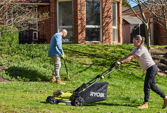 A couple using their Ryobi products in the front garden