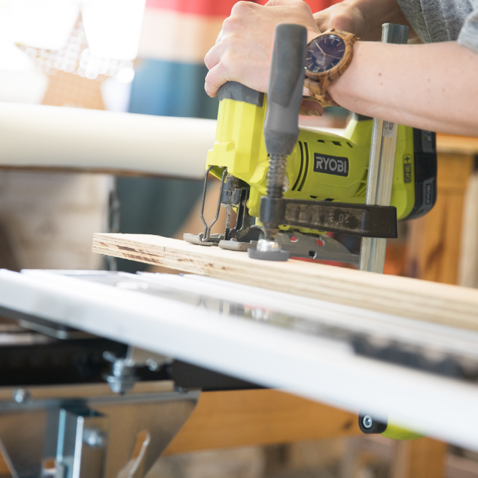 A Ryobi jigsaw being used to cut wood