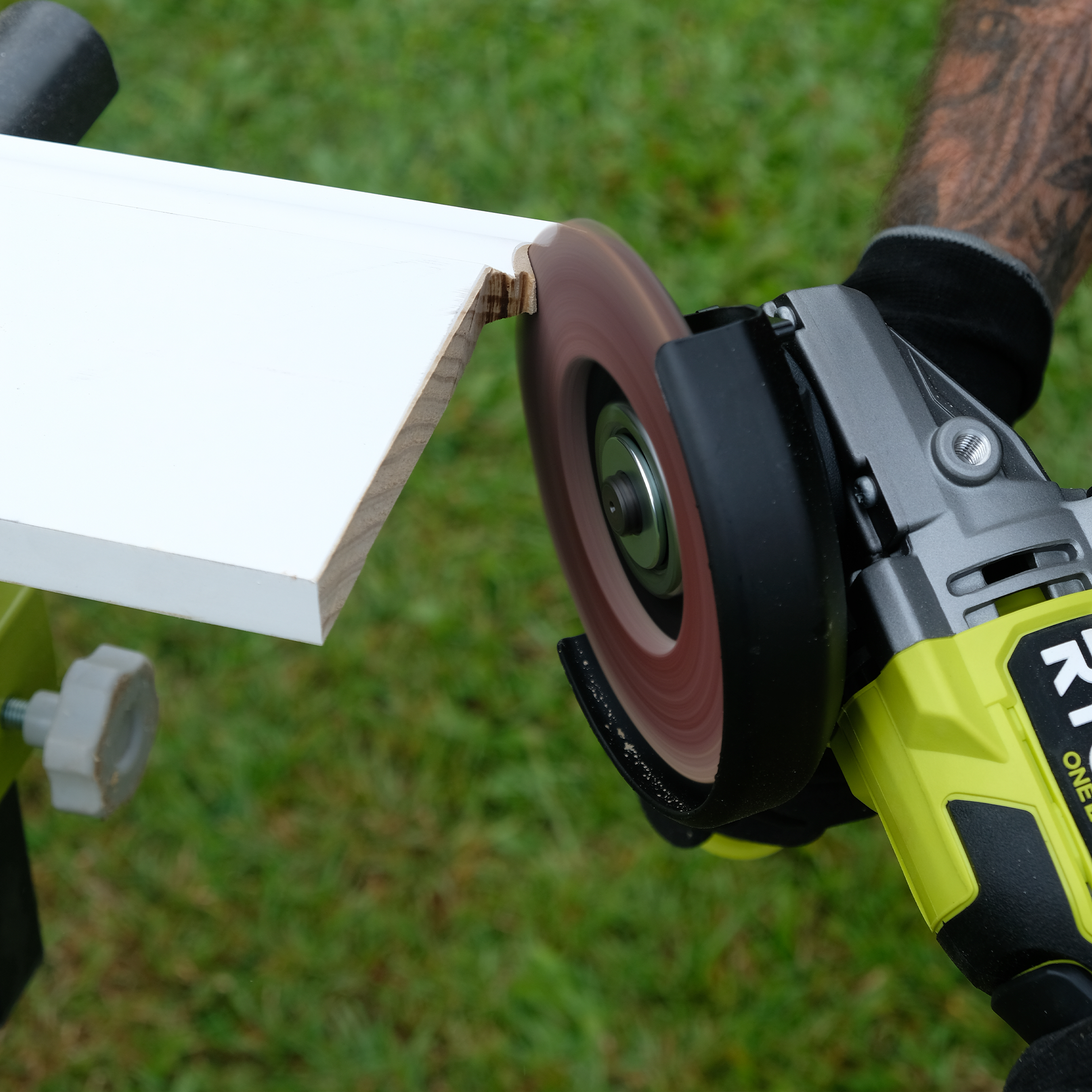 Jake uses a RYOBI angle grinder with a flap disk to remove excess material.  