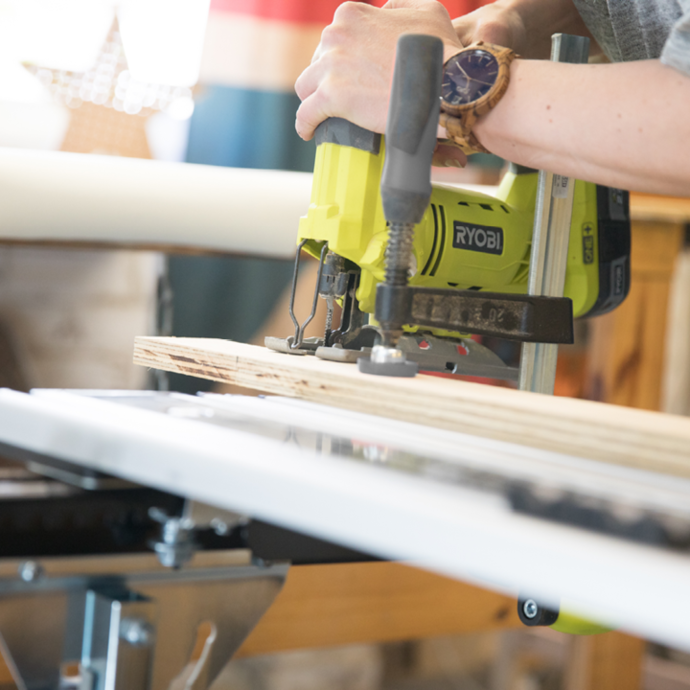 A Ryobi jigsaw being used to cut wood