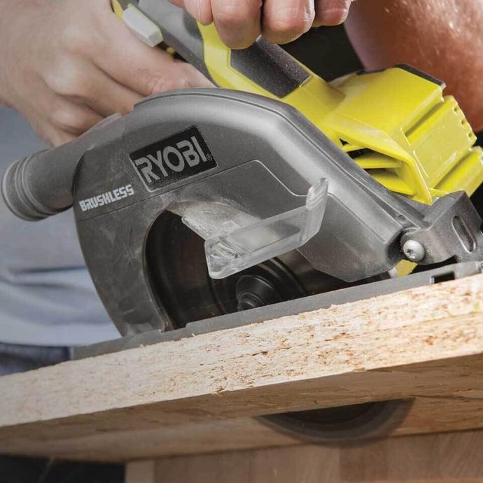 A Ryobi circular saw being used to cut through a plank of wood